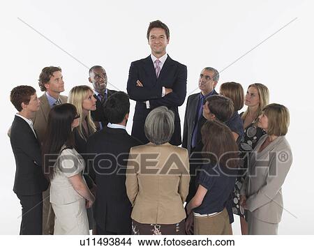 Group of Businesspeople Staring at Tall Man View Large Photo Image Picture - Group of Businesspeople Staring at Tall Man. Fotosearch