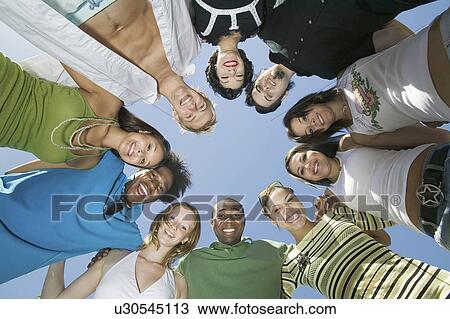 Stock Image - Group of friends in circle view from below portrait. Fotosearch
