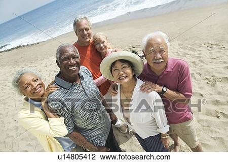 Stock Image - Group of friends on beach (portrait). Fotosearch
