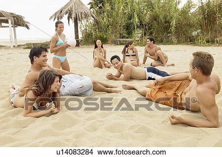 Picture - Group of Friends talking on the Beach. Fotosearch