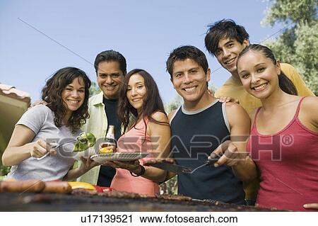 Group of young people around outdoor grill portrait View Large Photo Image Stock Image - Group of young people around outdoor grill portrait. Fotosearch