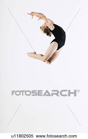 Gymnast (16-17) leaping in air side view View Large Photo Image Stock Photography - Gymnast (16-17) leaping in air side view. Fotosearch