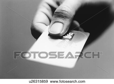 Hand holding credit card (close-up) (b&w) View Large Photo Image Stock Photo - Hand holding credit card (close-up) (b&w). Fotosearch