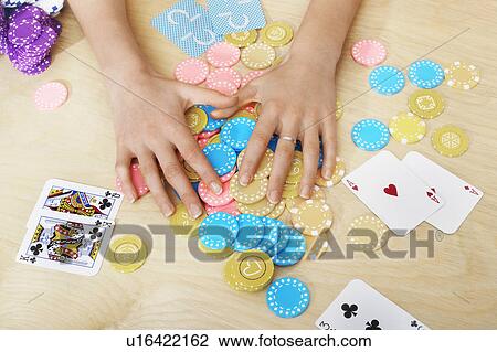 Hands of woman Grabbing Gambling Chips on table close up of hands overhead view View Large Photo Image Stock Image - Hands of woman Grabbing Gambling Chips on table close up of hands overhead view. Fotosearch