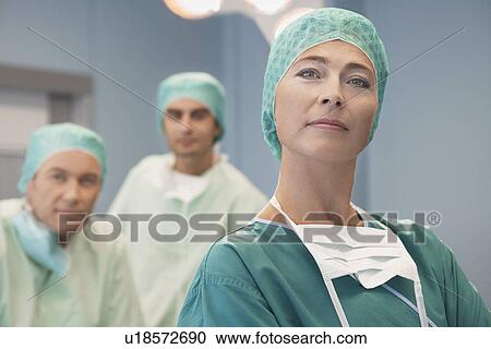 Head of Surgical Team with surgeons in operating theatre portrait View Large Photo Image Stock Image - Head of Surgical Team with surgeons in operating theatre portrait. Fotosearch