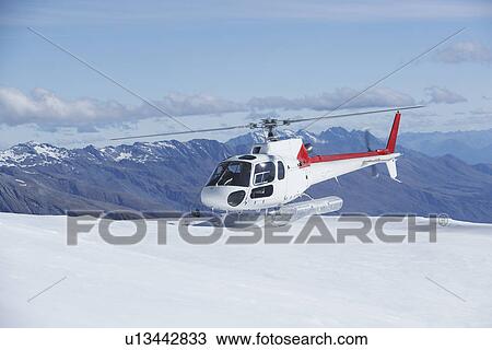 Helicopter landing on snowy mountain top View Large Photo Image Stock Image - Helicopter landing on snowy mountain top. Fotosearch