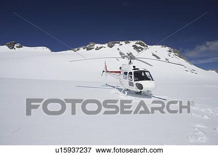Helicopter landing on snowy mountain top View Large Photo Image Stock Photo - Helicopter landing on snowy mountain top. Fotosearch