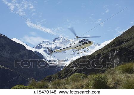 Helicopter over mountains View Large Photo Image Stock Photo - Helicopter over mountains. Fotosearch