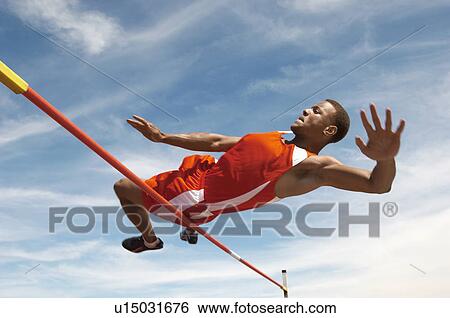 High Jumper in mid air over bar low angle view View Large Photo Image Stock Photograph - High Jumper in mid air over bar low angle view. Fotosearch