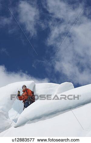 Hiker standing on ice chunks View Large Photo Image Stock Photo - Hiker standing on ice chunks. Fotosearch