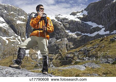 Hiker using walkie-talking on mountain View Large Photo Image Stock Photo - Hiker using walkie-talking on mountain. Fotosearch