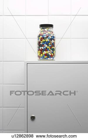 Jar of pills on bathroom cabinet View Large Photo Image Stock Photo - Jar of pills on bathroom cabinet. Fotosearch