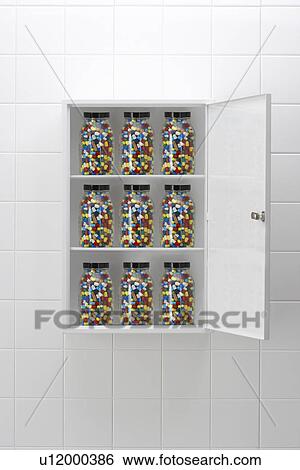 Jars of pills in bathroom cabinet View Large Photo Image Stock Photograph - Jars of pills in bathroom cabinet. Fotosearch