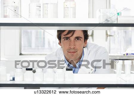 Stock Image - Lab Worker Looking Through Shelves. Fotosearch
