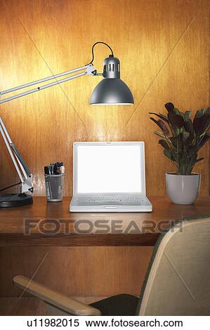 Laptop with blank screen and other items on desk with chair View Large Photo Image Stock Photography - Laptop with blank screen and other items on desk with chair. Fotosearch