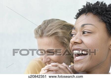 Laughing young women holding hands portrait View Large Photo Image Stock Image - Laughing young women holding hands portrait. Fotosearch