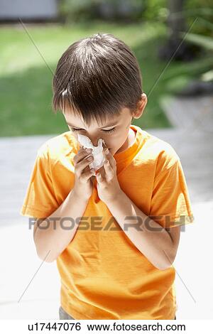 Stock Photograph - Little Boy Blowing His Nose in back yard. Fotosearch