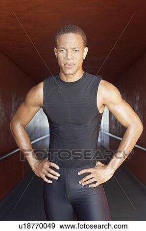 Stock Photo - Male athlete half length with hands on hips. Fotosearch