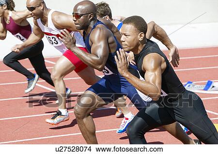 Male athletics sprinting on running track View Large Photo Image Picture - Male athletics sprinting on running track. Fotosearch