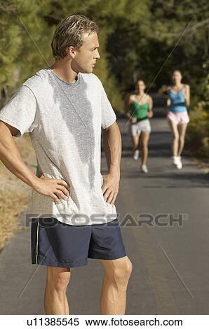 Male jogger pausing for breath on path View Large Photo Image Stock Photography - Male jogger pausing for breath on path. Fotosearch