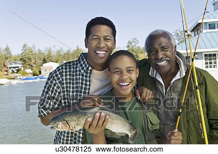 Male members of three generation family showing fish smiling (portrait) View Large Photo Image Stock Photography - Male members of three generation family showing fish smiling (portrait). Fotosearch