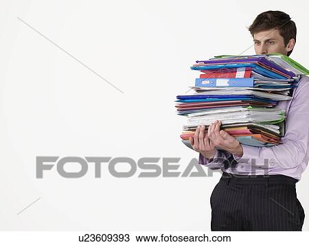 Male office worker carrying heavy binders on white background View Large Photo Image Stock Image - Male office worker carrying heavy binders on white background. Fotosearch