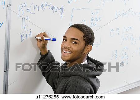Male student writing equations on whiteboard (portrait) View Large Photo Image Stock Photography - Male student writing equations on whiteboard (portrait). Fotosearch