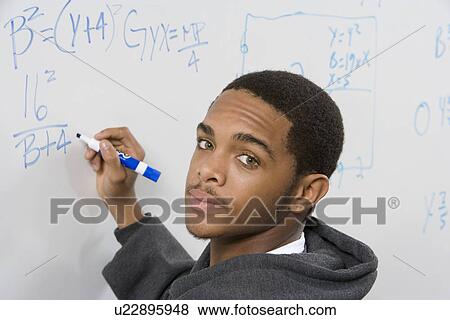 Male student writing maths equations on whiteboard View Large Photo Image Stock Photo - Male student writing maths equations on whiteboard. Fotosearch