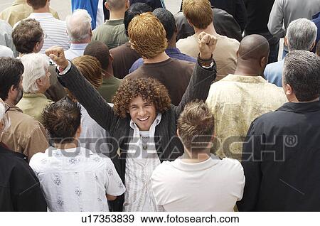 Man facing the other way to rest of crowd elevated view View Large Photo Image Stock Photo - Man facing the other way to rest of crowd elevated view. Fotosearch