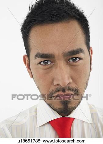 Stock Photography - Man Frowning in studio head and shoulders. Fotosearch