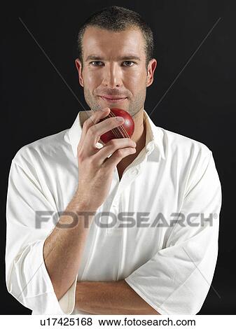 Man holding cricket ball portrait View Large Photo Image Stock Photo - Man holding cricket ball portrait. Fotosearch