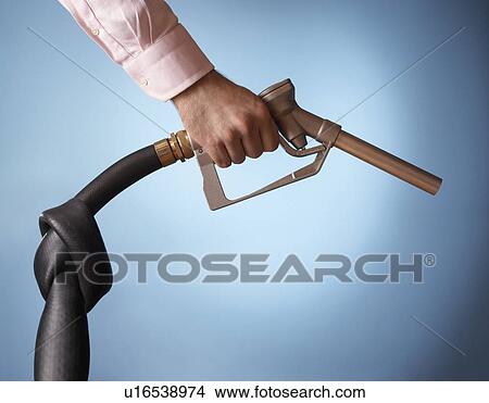 Man holding fuel pump with knot in pipe close up of hand View Large Photo Image Picture - Man holding fuel pump with knot in pipe close up of hand. Fotosearch