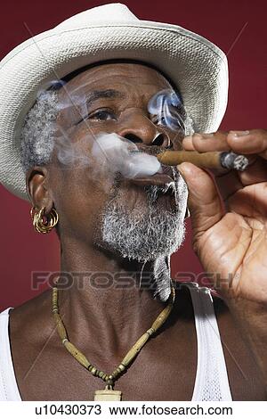 Man in Fedora Smoking Cigar View Large Photo Image Stock Image - Man in Fedora Smoking Cigar. Fotosearch