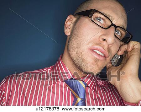 Man in glasses on cell phone head and shoulders View Large Photo Image Stock Photo - Man in glasses on cell phone head and shoulders. Fotosearch