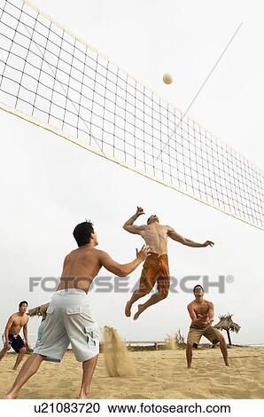 Man in Mid-air Going for Volleyball on beach View Large Photo Image Stock Image - Man in Mid-air Going for Volleyball on beach. Fotosearch