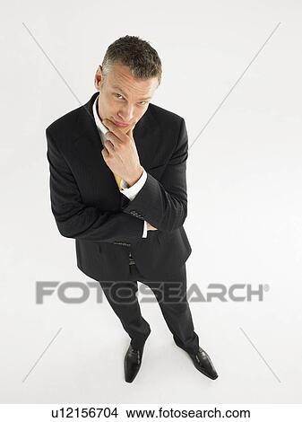 Man in suit in studio elevated view full length View Large Photo Image Picture - Man in suit in studio elevated view full length. Fotosearch
