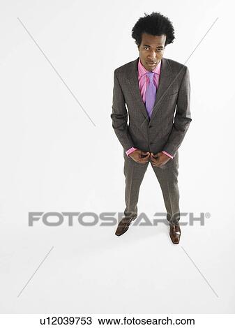 Stock Image - Man in suit in studio elevated view. Fotosearch