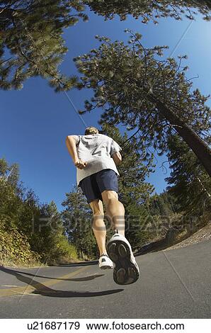 Man jogging down road back view View Large Photo Image Stock Photo - Man jogging down road back view. Fotosearch