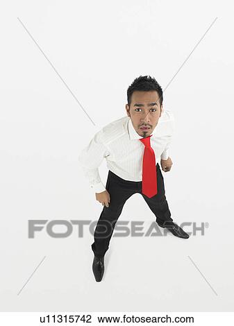Man looking up in studio full length elevated view View Large Photo Image Stock Image - Man looking up in studio full length elevated view. Fotosearch