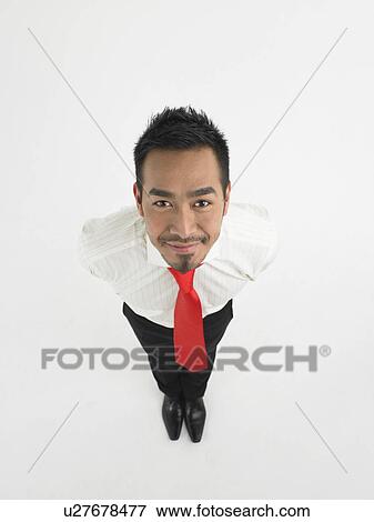 Man looking up in studio full length elevated view View Large Photo Image Stock Photo - Man looking up in studio full length elevated view. Fotosearch