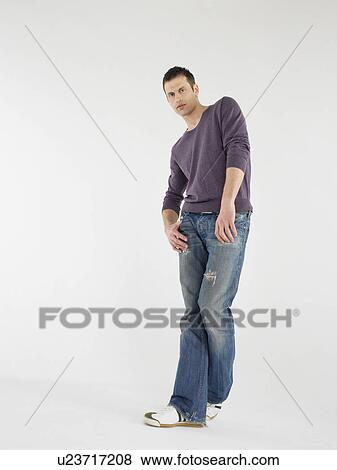 Stock Photo - Man posing in studio full length. Fotosearch