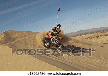 Man riding quad bike in desert View Large Photo Image Stock Photograph - Man riding quad bike in desert. Fotosearch
