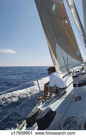 Stock Image - Man Sailing on Yacht. Fotosearch