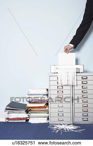 Man shredding document close-up of hand in office View Large Photo Image Stock Image - Man shredding document close-up of hand in office. Fotosearch