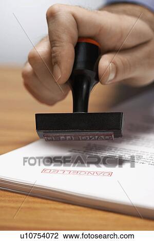 Man Using "Cancelled" Stamp View Large Photo Image Stock Image - Man Using "Cancelled" Stamp. Fotosearch