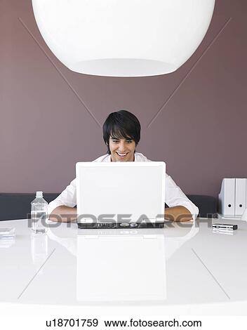 Man Using Laptop at White Table View Large Photo Image Stock Photo - Man Using Laptop at White Table. Fotosearch