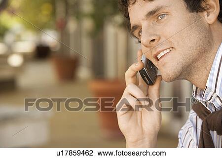Man using mobile phone outdoors close-up View Large Photo Image Stock Image - Man using mobile phone outdoors close-up. Fotosearch