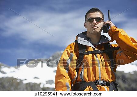 Man using walkie-talkie on mountain peak View Large Photo Image Stock Image - Man using walkie-talkie on mountain peak. Fotosearch