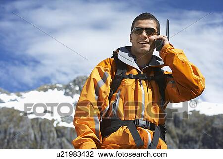 Man using walkie-talking on mountain peak View Large Photo Image Stock Image - Man using walkie-talking on mountain peak. Fotosearch