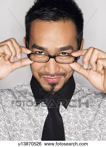 Man wearing glasses and smiling in studio portrait head and shoulders View Large Photo Image Stock Photograph - Man wearing glasses and smiling in studio portrait head and shoulders. Fotosearch